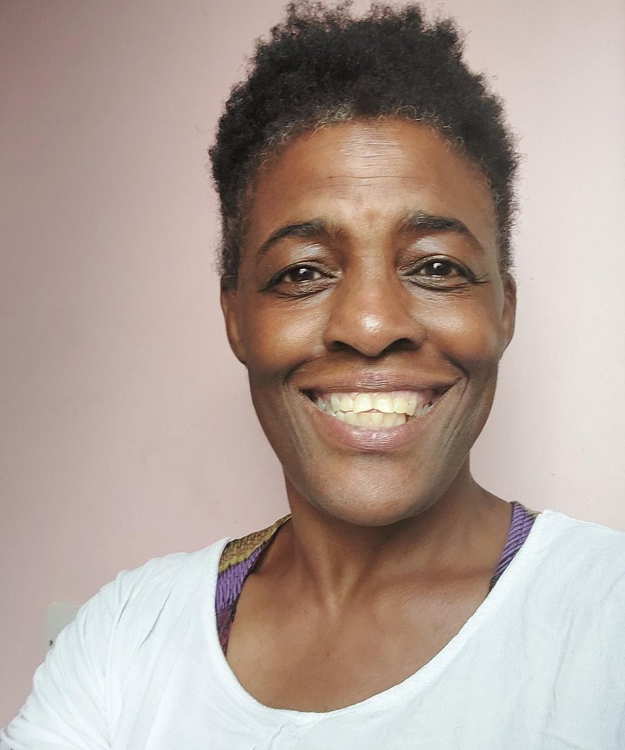 Adedayo, smiling warmly to camera.